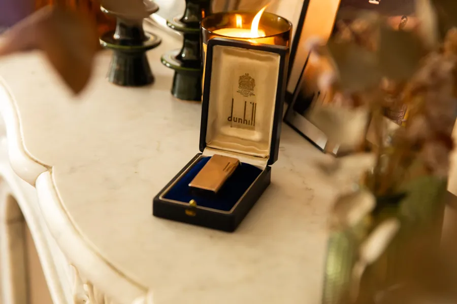 Dunhill Aldunil lighter in its original box on a marble mantelpiece, by candlelight