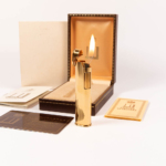 Vintage Gold Dunhill Dress lighter in front of box lit