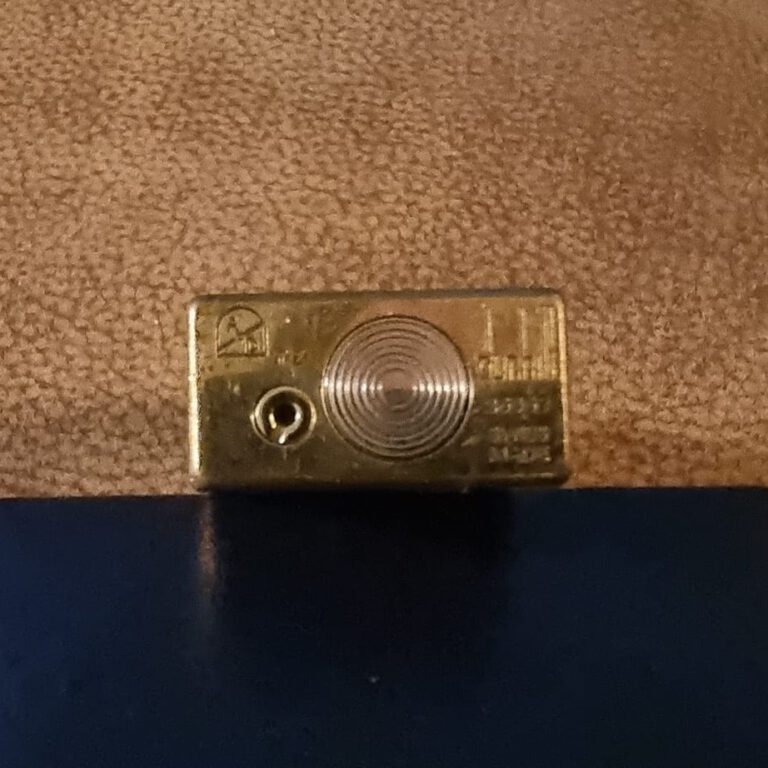 Base of a fake Dunhill Rollagas with the burner screw halfway along the end and blurred markings