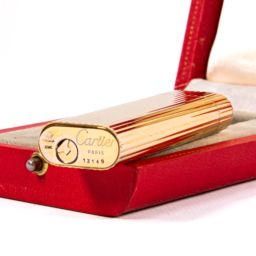 Base of an early Cartier lighter: a solid bottom plate marked Cartier Paris 13149 with only the round flint screw and no hinged filling cover
